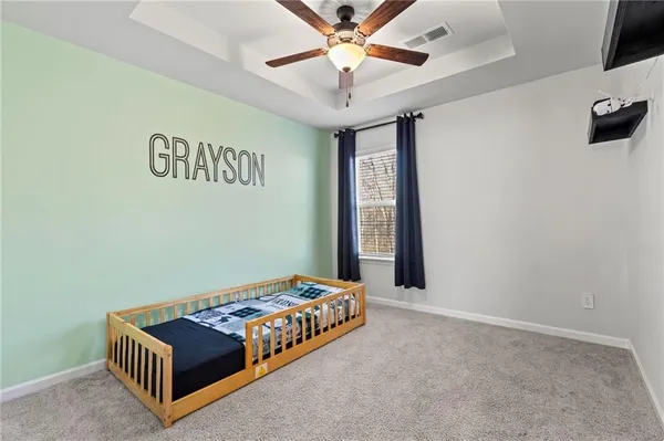 a bedroom with bed and a chandelier