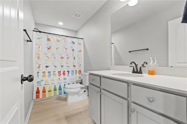a bathroom with a sink toilet and shower