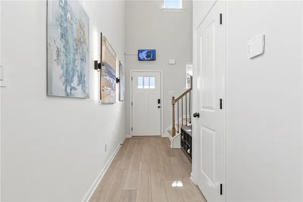 a view of a hallway with wooden floor and entryway