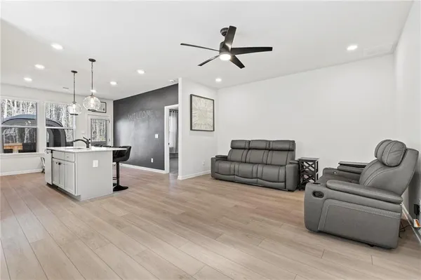 a living room with furniture and kitchen view