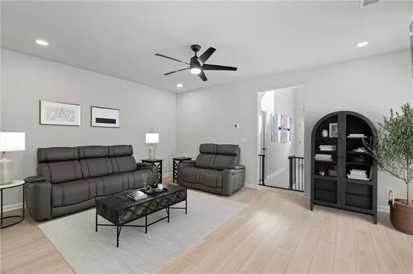 a living room with furniture and wooden floor