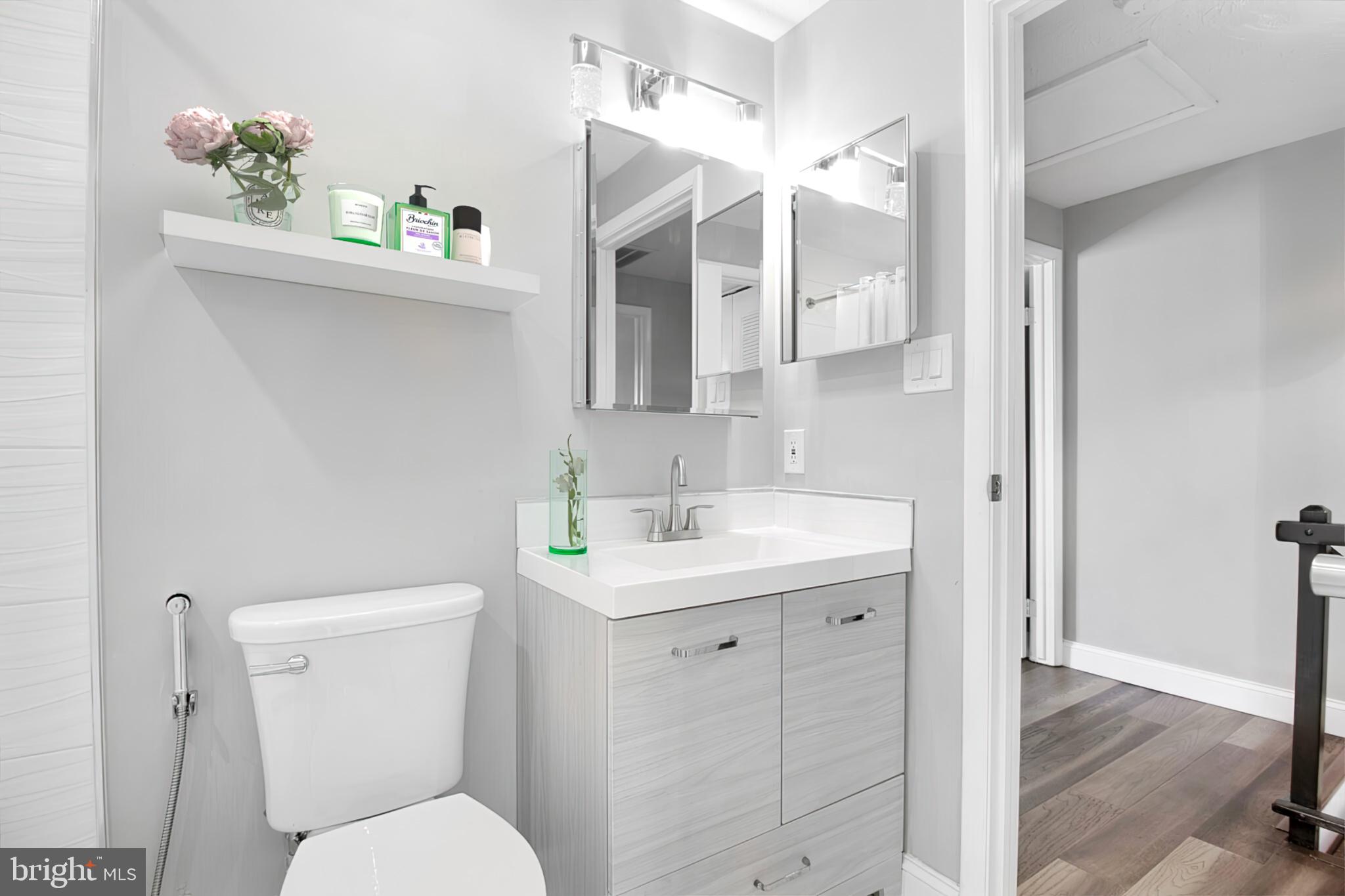 1456 Farmcrest Way Silver Spring, MD 20905 - Photo 16 of 24 a bathroom with a toilet sink and mirror