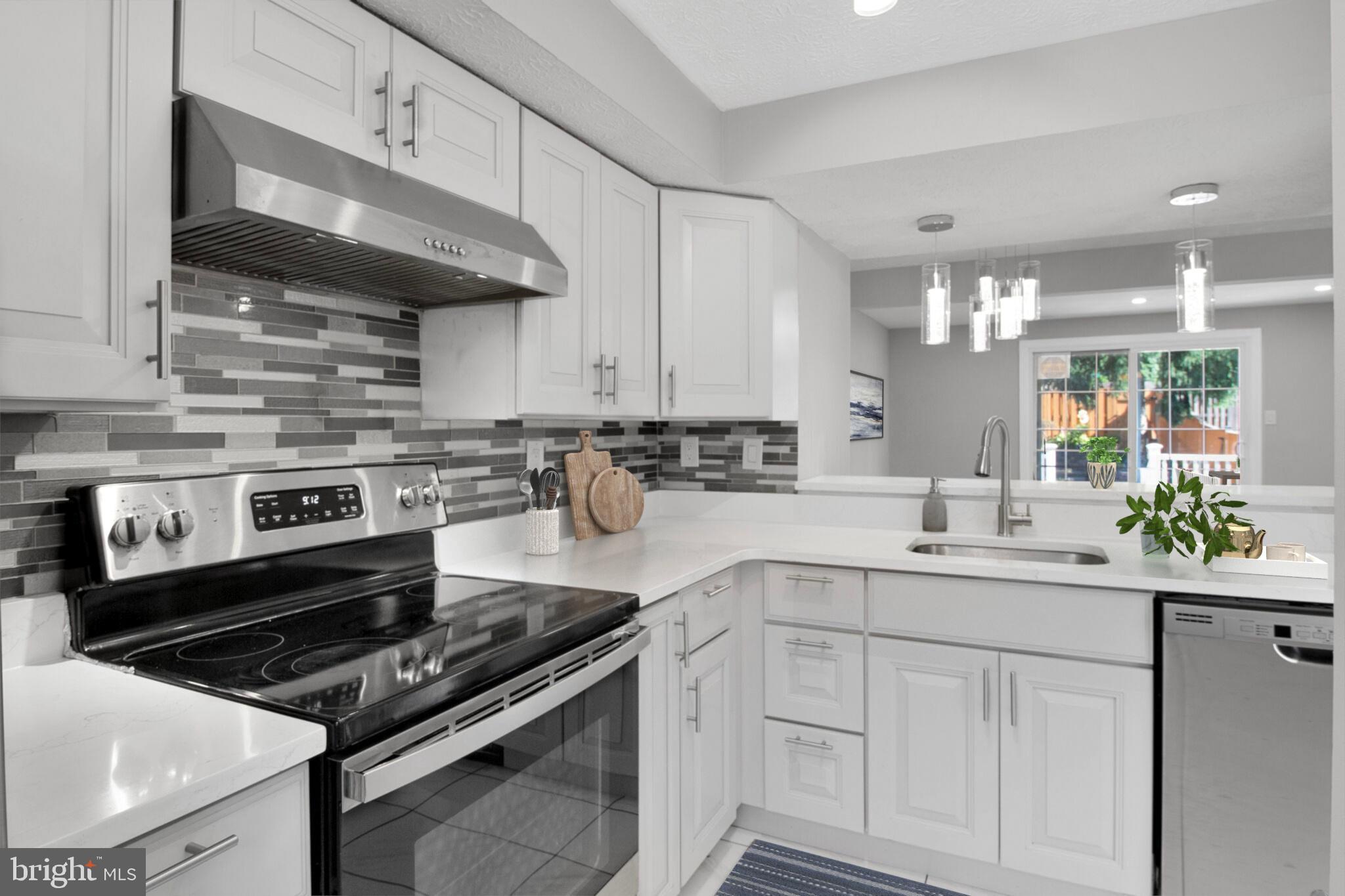 1456 Farmcrest Way Silver Spring, MD 20905 - Photo 4 of 24 a kitchen with stainless steel appliances a sink a stove and cabinets