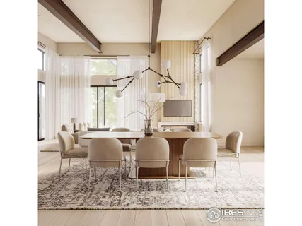 a living room with couches chairs and large mirror with wooden floor