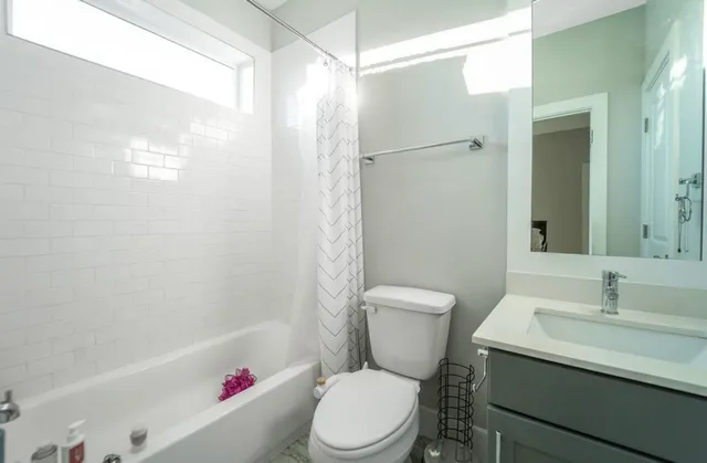 a white toilet sitting next to a bathroom sink