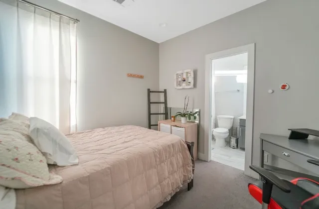 a bedroom with a bed and a tv on the dresser