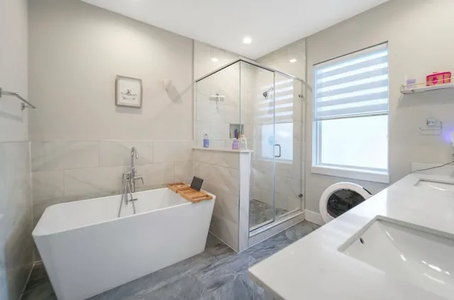 a living room with furniture a flat screen tv and a dining table