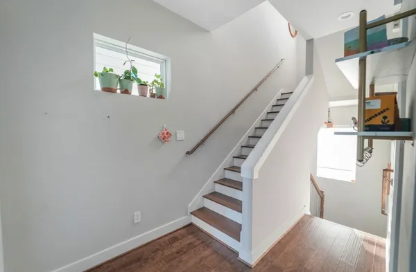 a view of entryway with furniture and wooden floor