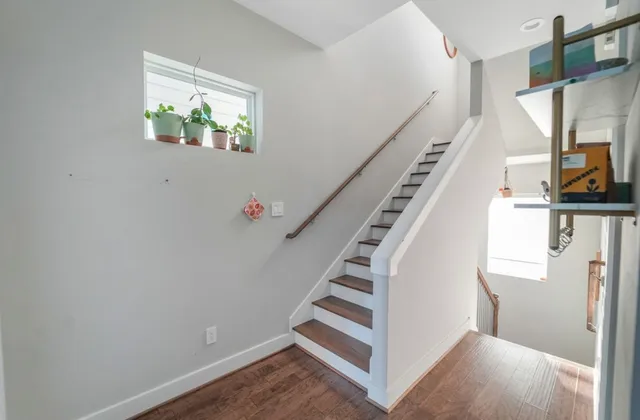 a view of entryway with furniture and wooden floor