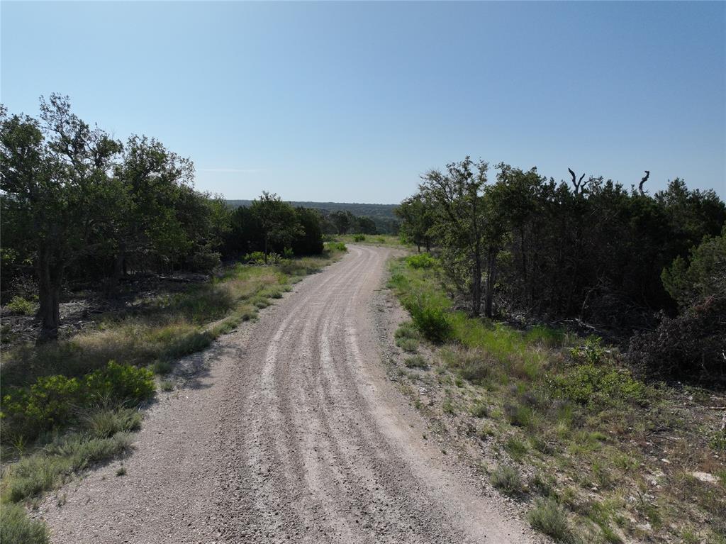 2414 - Tract 2 Evant, TX 76525 - Photo 21 of 29 a view of a street with a trees in the background