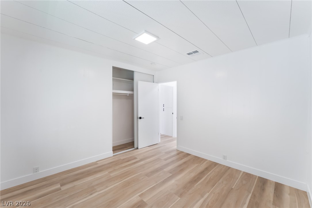 4980 Ridge Drive Las Vegas, NV 89103 - Photo 22 of 36 Unfurnished bedroom with a closet and light wood-style flooring