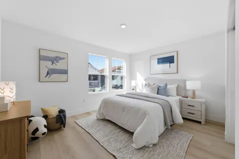 a bedroom with bed and a couch