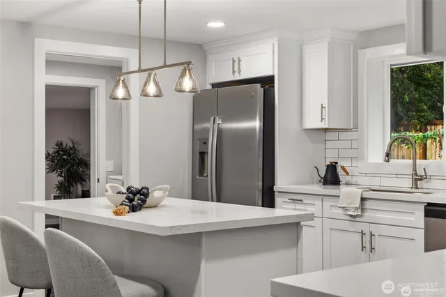 a kitchen with a refrigerator and a sink
