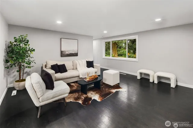 a living room with furniture and a potted plant