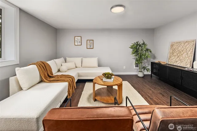 a living room with furniture and a potted plant