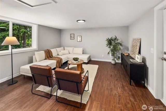 a living room with furniture a window and a flat screen tv