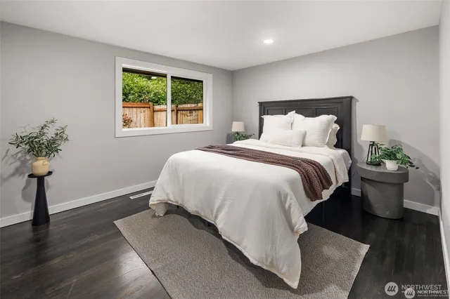 a bed sitting in a bedroom next to a window