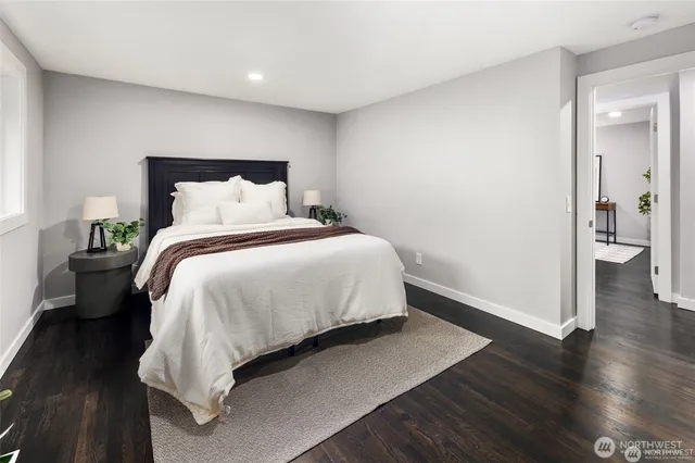 a large bed sitting in a bedroom and wooden floor