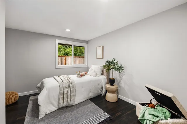 a bedroom with a bed and a potted plant