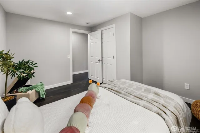 a bedroom with a bed and a potted plant