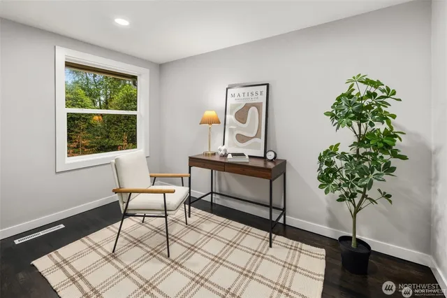 a living room with furniture and a potted plant