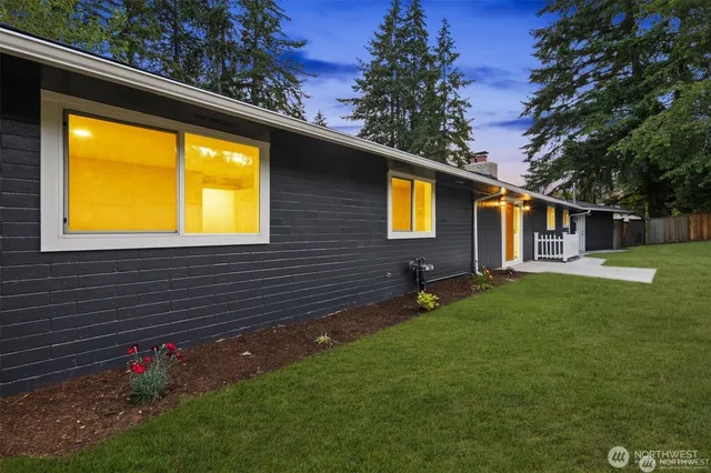 an aerial view of residential houses with outdoor space and ocean view