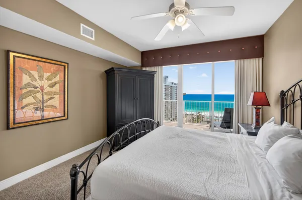 a large bedroom with a large bed and a large window
