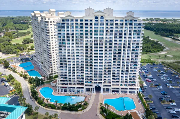 an aerial view of residential houses with outdoor space and swimming pool