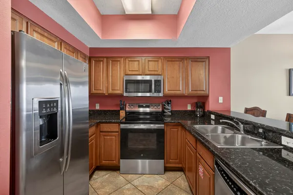 a kitchen with a sink stove and refrigerator