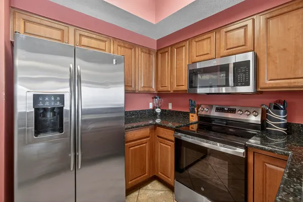 a kitchen with a refrigerator stove and cabinets