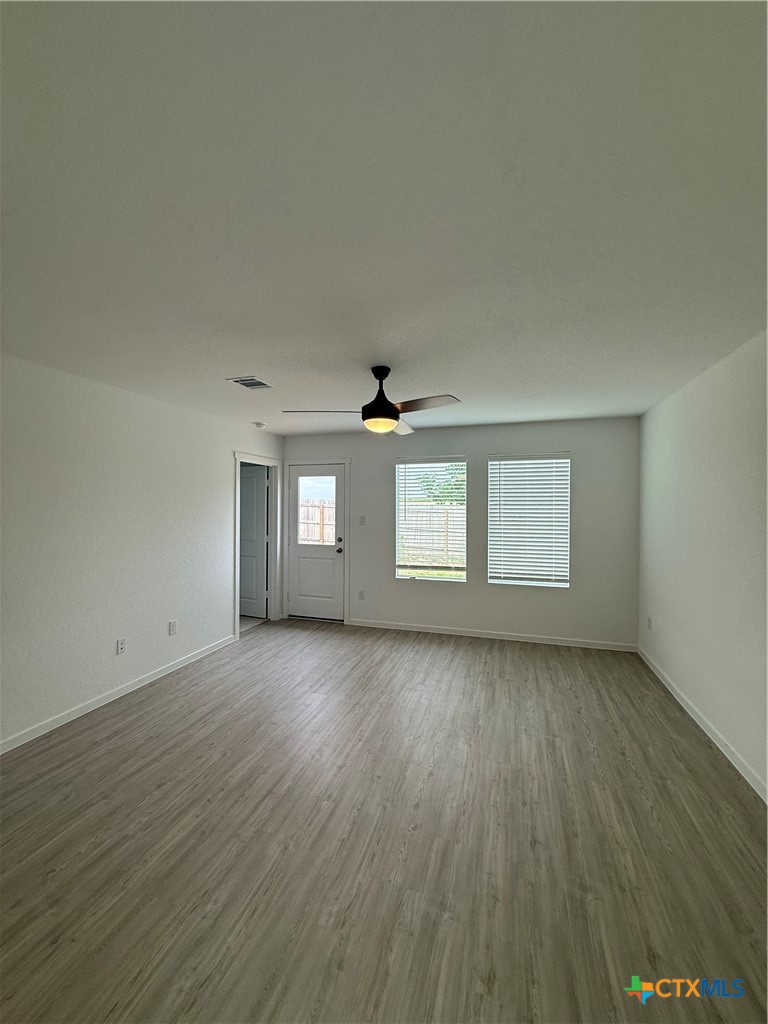 3230 Mound Ridge New Braunfels, TX 78130 - Photo 3 of 15 an empty room with wooden floor and windows