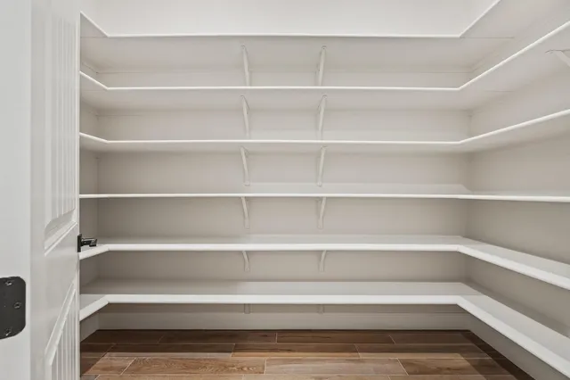 a view of walk in closet with empty racks