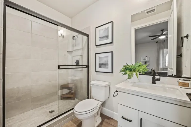 a bathroom with a sink toilet and shower