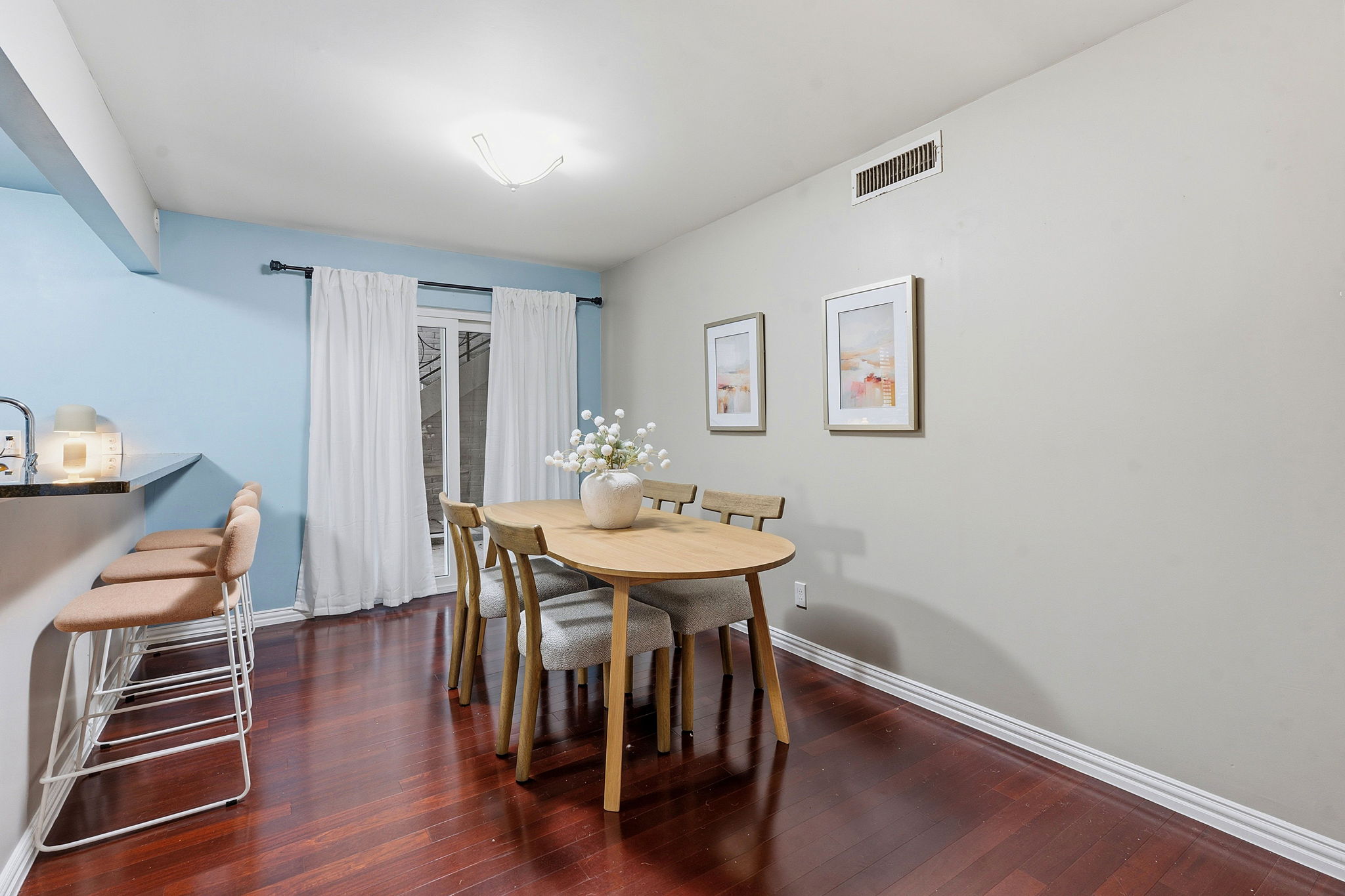 1210 Windsor Road, Unit 104 Austin, TX 78703 - Photo 8 of 29 Rich hardwood floors complement a versatile dining space, ideal for entertaining or casual meals.