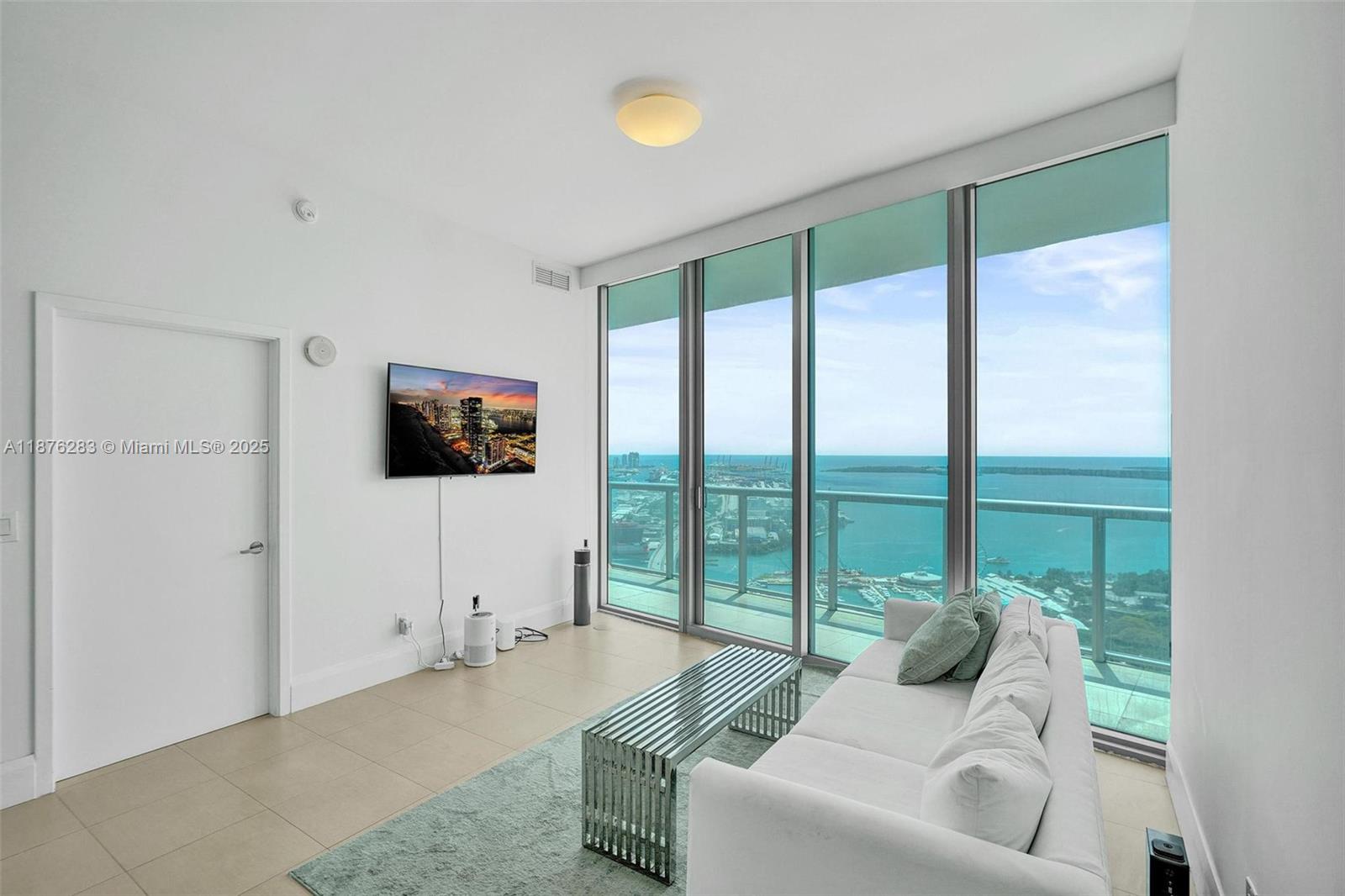 888 Biscayne Boulevard, Unit 5102 Miami, FL 33132 - Photo 4 of 34 a living room with furniture and a flat screen tv