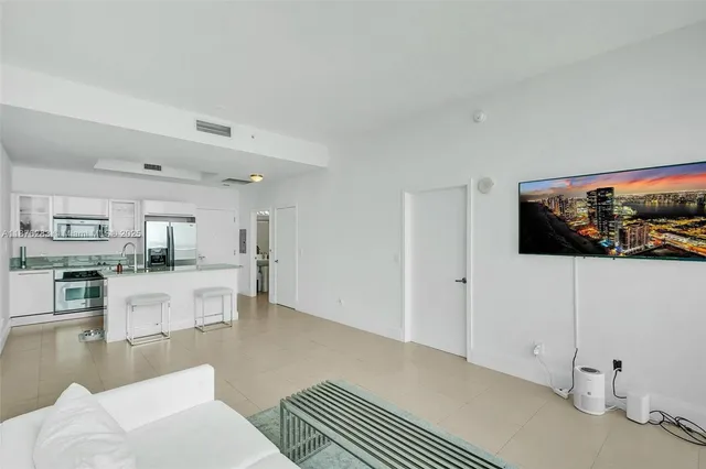 a living room with furniture and a floor to ceiling window