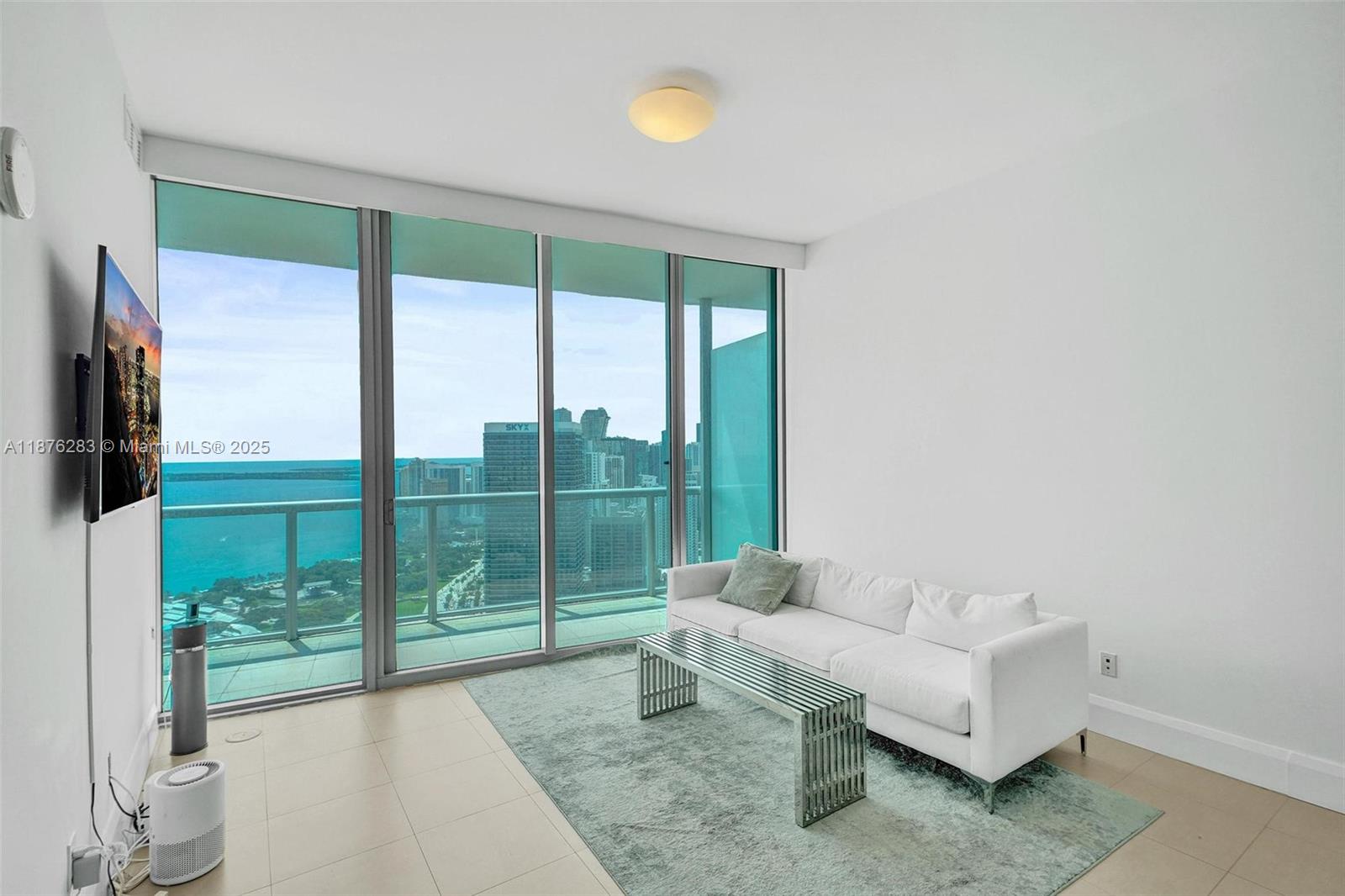 888 Biscayne Boulevard, Unit 5102 Miami, FL 33132 - Photo 6 of 34 a living room with furniture and a floor to ceiling window