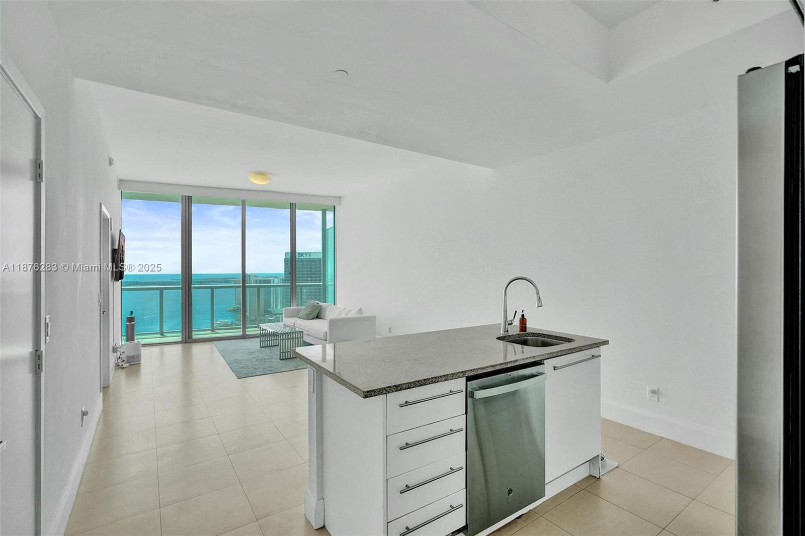 888 Biscayne Boulevard, Unit 5102 Miami, FL 33132 - Photo 7 of 34 a kitchen with granite countertop a sink and a stove