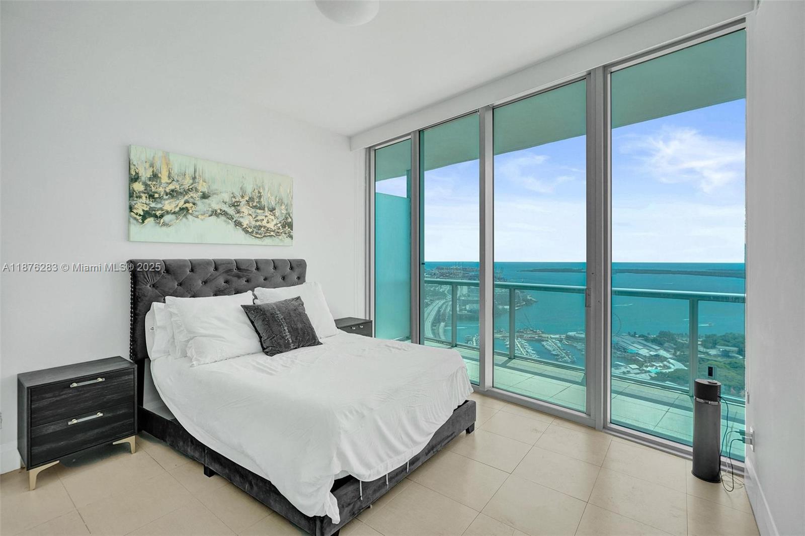 888 Biscayne Boulevard, Unit 5102 Miami, FL 33132 - Photo 8 of 34 a bedroom with a bed and a large window