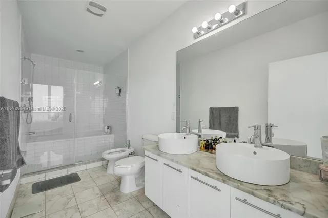 a bathroom with a sink toilet and mirror