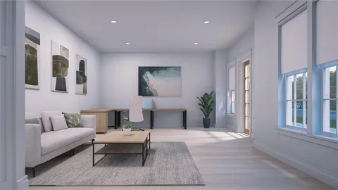 a living room with furniture and painting on the wall