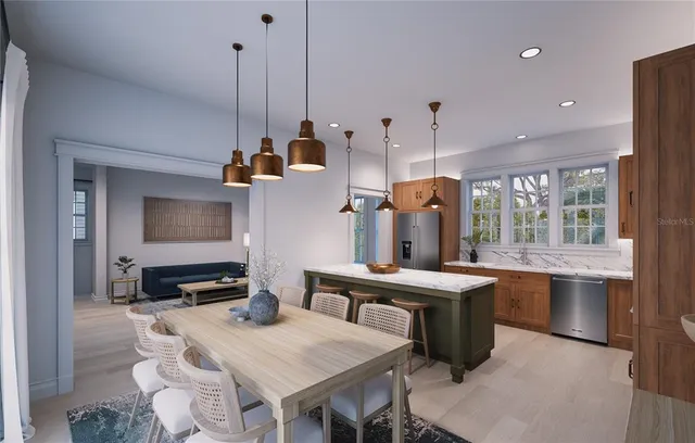 a kitchen island with a table chairs stove and wooden floor