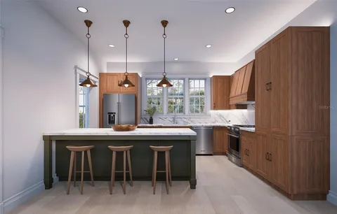 a kitchen with kitchen island granite countertop a sink a counter top space stainless steel appliances and cabinets