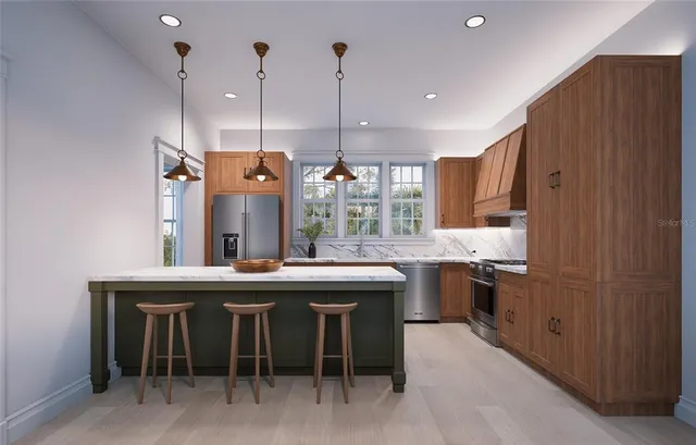 a kitchen with kitchen island granite countertop a sink a counter top space stainless steel appliances and cabinets