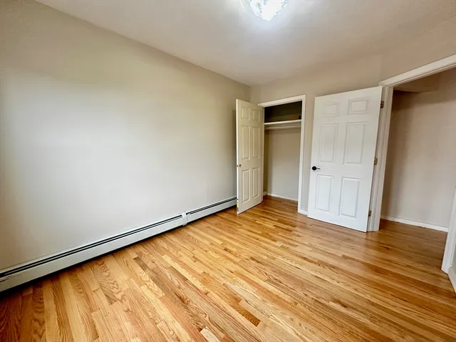 a view of an empty room and wooden floor