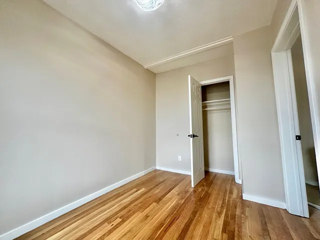 a view of a room with wooden floor and closet