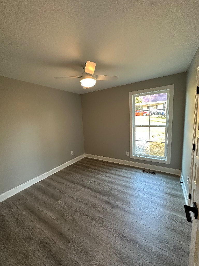 1295 Bethel Road Pulaski, TN 38478 - Photo 5 of 17 a view of empty room with wooden floor and fan