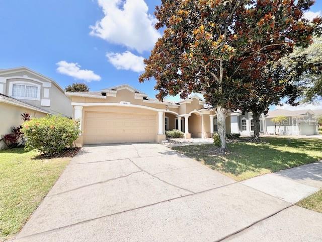 a front view of a house with a yard and a garage