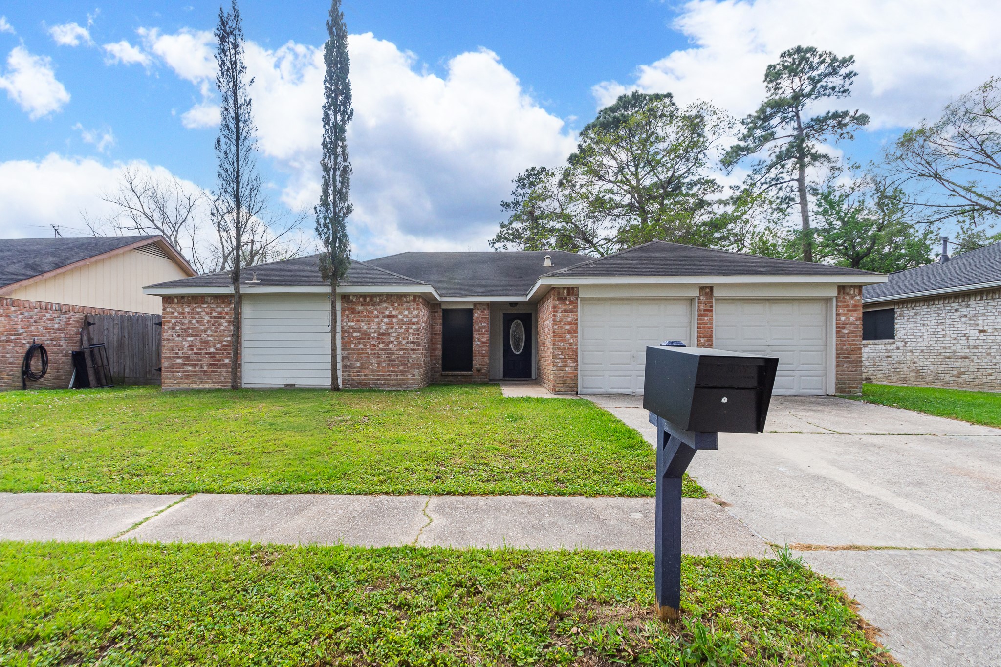 29019 Stapleford Street Spring, TX 77386 - Photo 2 of 27 a front view of a house with a garden and yard