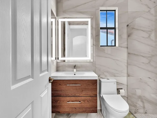 a view of a bathroom from a hallway